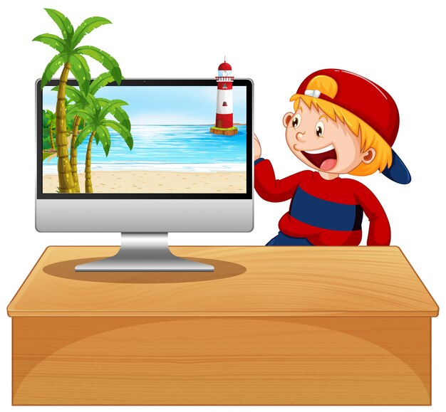 Niño feliz junto a la computadora con escena de playa en pantalla
