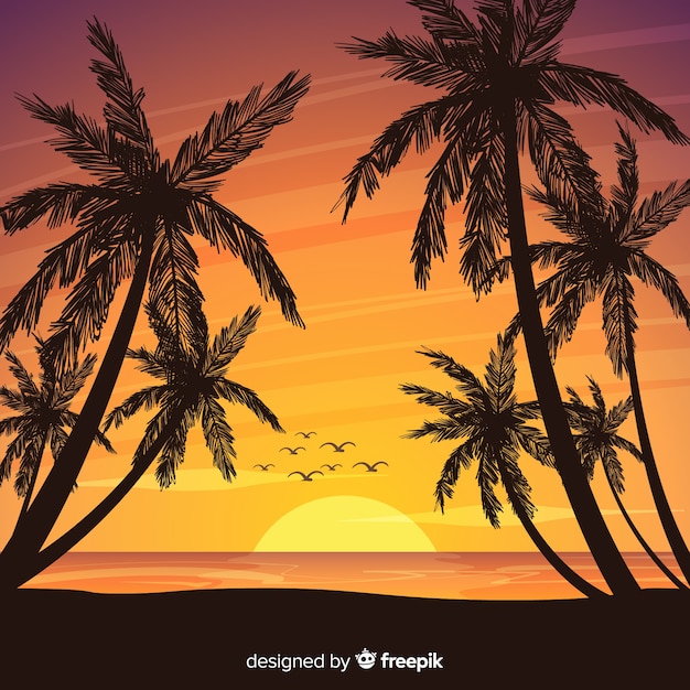 Puesta de sol en la playa con silueta de palmeras