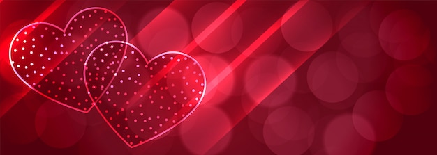 Romántico dos corazones brillantes bokeh banner background