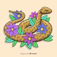 Vector gratuito serpiente dibujada a mano con flores