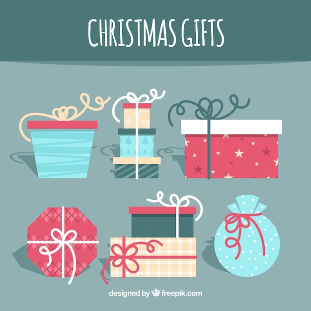 Vector gratuito set de regalos de navidad en diseño plano