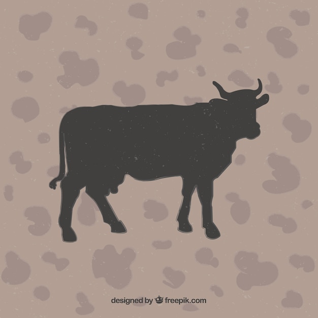 Vector gratuito silueta de vaca en fondo de estampado animal