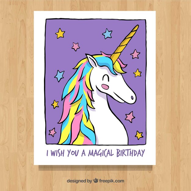 Tarjeta dibujada a mano con unicornio y estrellas