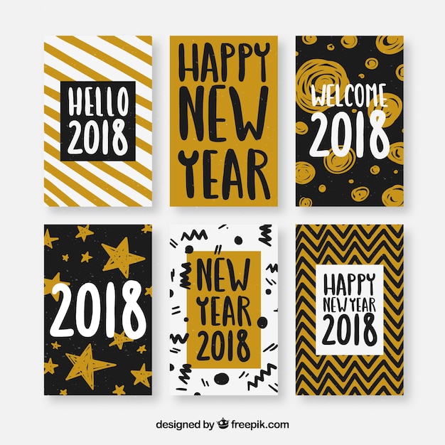 Tarjetas de felicitación de año nuevo con varios patrones amarillos, negros y blancos