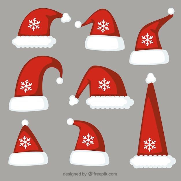 Vector gratuito variedad de gorros de santa claus y copos de nieve