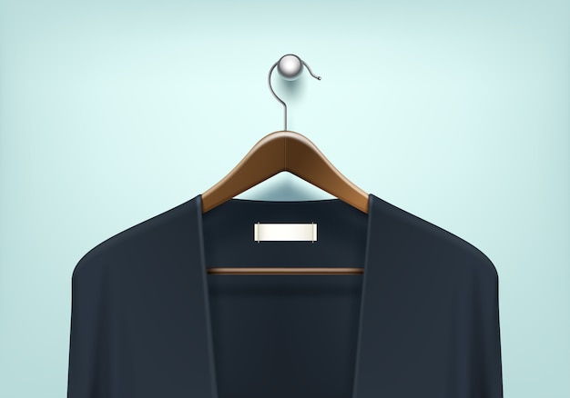 Abrigo de ropa Percha de madera marrón con suéter negro azul Cardigan Jumper con etiqueta de etiqueta en blanco Cerrar aislado sobre fondo