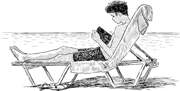 Un adolescente lee un libro en la playa