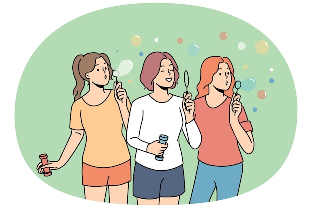Las adolescentes inflan burbujas de jabón disfrutando de la recreación al aire libre en el calor del verano