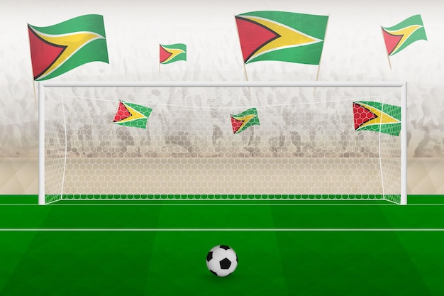 Aficionados del equipo de fútbol de Guyana con banderas de Guyana animando el concepto de tiro penal del estadio en un partido de fútbol