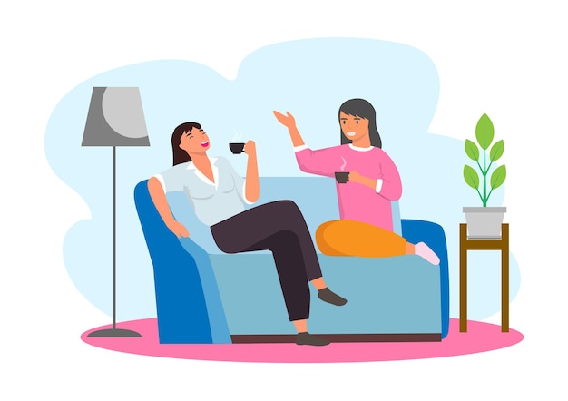 Amigas sentadas y charlando en el sofá y bebiendo té en casa