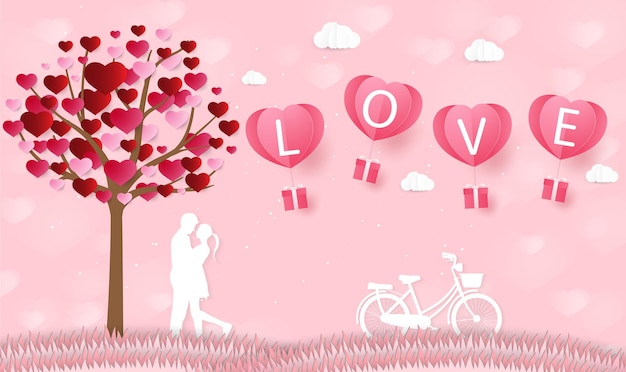 Amor y día de San Valentín Los amantes se paran en los prados y un globo en forma de corazón de arte de papel flotando