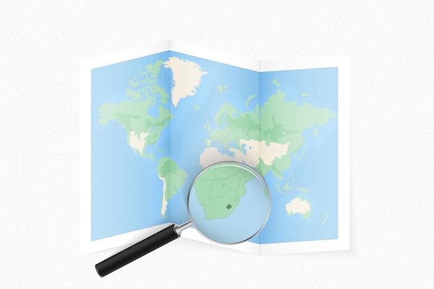 Ampliar Lesotho con una lupa en un mapa del mundo plegado