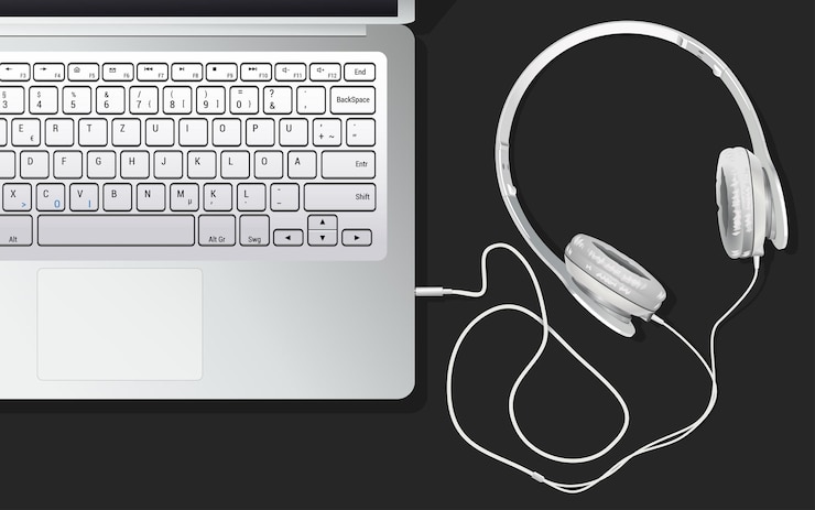 Vector los auriculares y la computadora portátil están sobre la mesa, conectados entre sí. escuchar música desde la computadora portátil. un portátil blanco sobre una mesa negra. ilustración