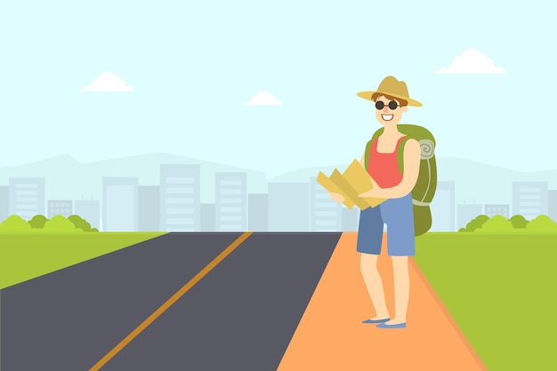 Un autoestopista masculino viajando con una mochila y un tipo de mapa tratando de detener un coche en la autopista con la mano de una persona