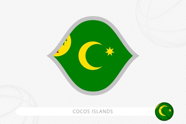 Bandera de las Islas Cocos para la competencia de baloncesto sobre fondo de baloncesto gris.