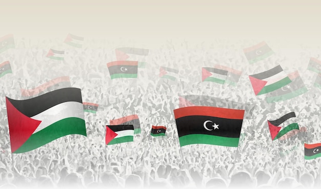 Banderas de Palestina y Libia en una multitud de gente aplaudiendo
