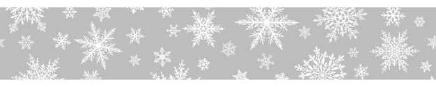 Banner navideño de copos de nieve grandes y pequeños complejos en colores blancos sobre fondo gris con repetición horizontal