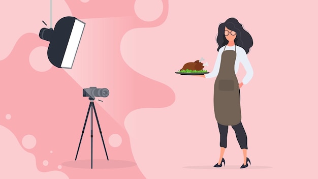 Bloguero culinario. una mujer con un delantal de cocina sostiene un pollo frito en una bandeja. cámara sobre trípode, softbox. el concepto de blog o vlog culinario. vector.