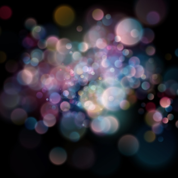 Bokeh circular desenfocado abstracto del color en fondo oscuro.
