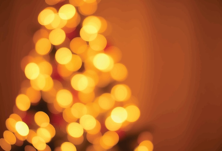 Vector bokeh dorado sobre un fondo negro