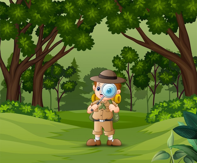 Boy explorer con lupa en el bosque