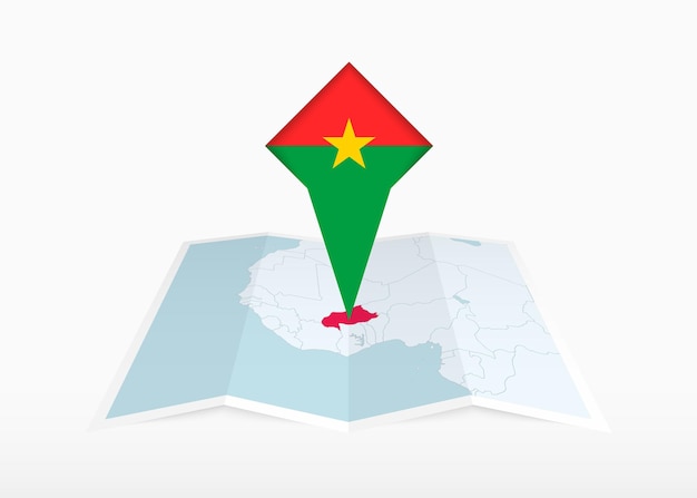 Burkina Faso está representada en un mapa de papel doblado y un marcador de ubicación fijado con la bandera de Burkina Faso.