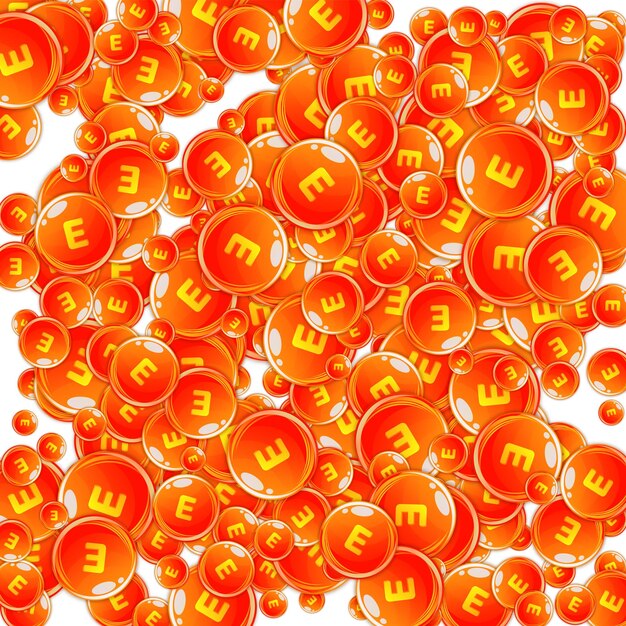 Cápsulas redondas de vitamina E esparcidas al azar.