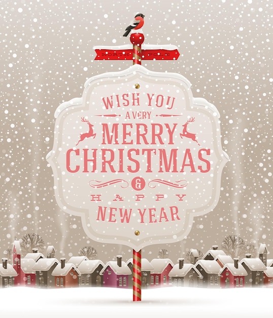 Cartel con saludo de Navidad contra un paisaje invernal con pueblo cubierto de nieve