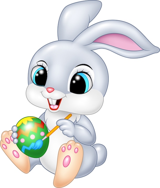 Cartoon funny Easter Bunny painting un huevo