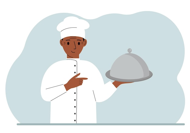 Un chef masculino con un plato cubierto con una campana o una bandeja con tapa