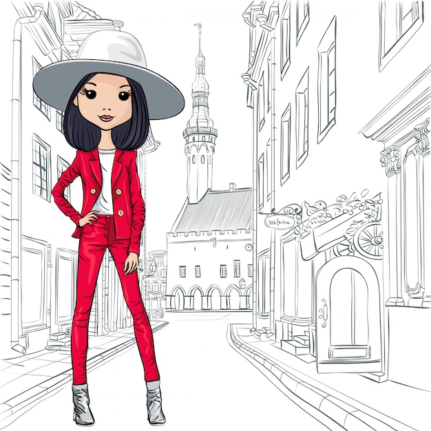 Chica de moda hermosa en ropa de otoño, traje y sombrero en una calle de la ciudad medieval de tallin