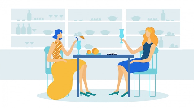 Chicas bebiendo cócteles en la cafetería o restaurante.