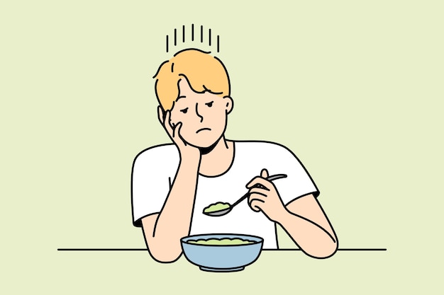 Chico sin apetito mira plato de dieta magra