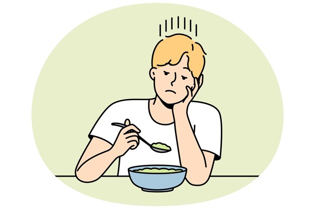 Chico sin apetito mira plato de dieta magra