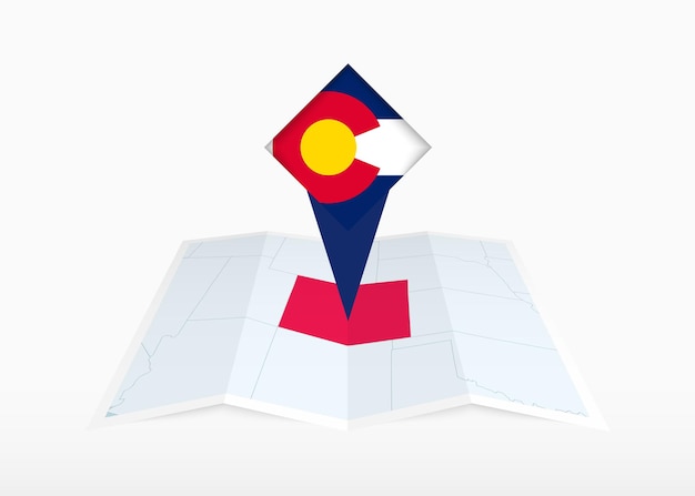 Colorado está representado en un mapa de papel plegado y marcador de ubicación fijado con la bandera de Colorado