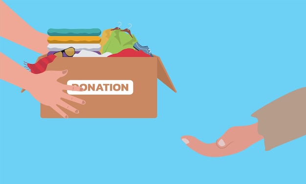 Concepto de caridad y donación de ropa. Caja de donación con ropa. Concepto de voluntariado y donación.