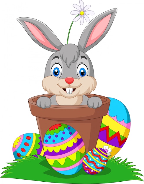 Conejito de dibujos animados en la olla con huevos de pascua en la hierba | Vector Premium Conejito de dibujos animados en la olla con huevos de pascua en la hierba | Vector Premium