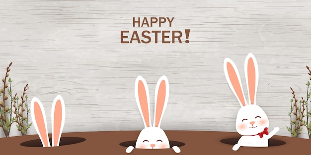 Conejos de Pascua mirando desde un agujero