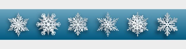Conjunto de Navidad de copos de nieve de papel blanco complejo con sombras suaves sobre fondo azul claro