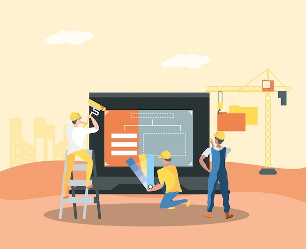 Constructor y computadora portátil con página web en construcción
