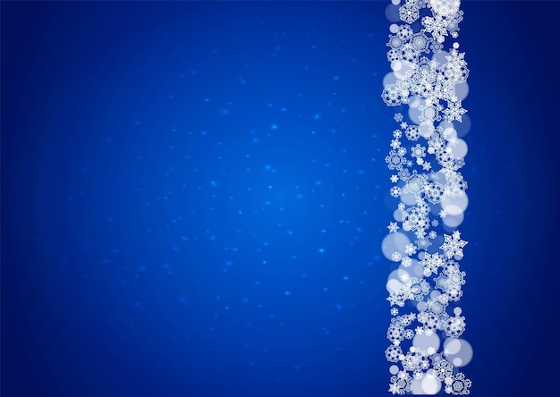 Los copos de nieve caen sobre un fondo azul
