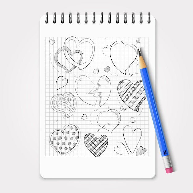 Corazones dibujados a mano con lápiz realista y cuaderno