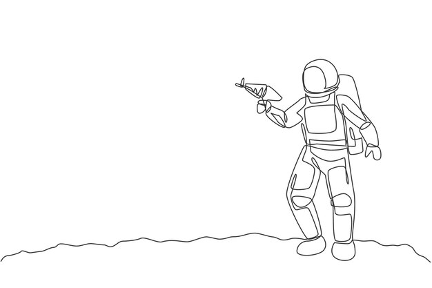 Dibujo de una sola línea continua de un joven astronauta sosteniendo una pistola láser espacial y posando para disparar en la luna