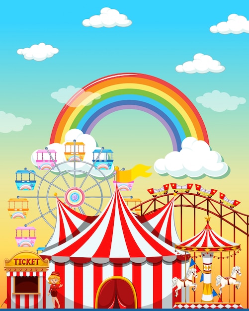 Escena del parque de atracciones durante el día con arco iris en el cielo