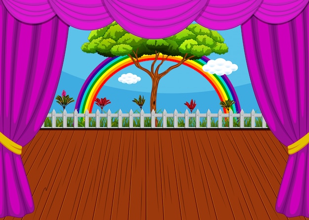 El escenario con arco iris y fondo de árbol.