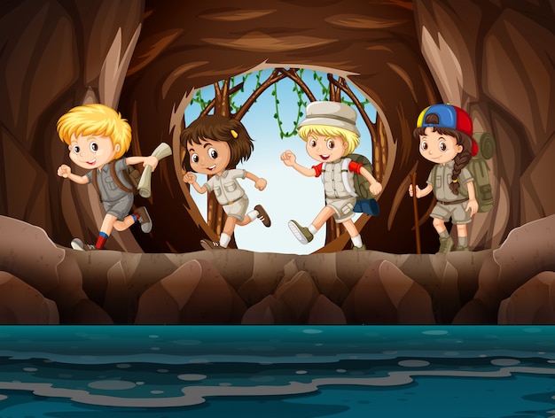 Exploradores de niños pequeños explorando una cueva