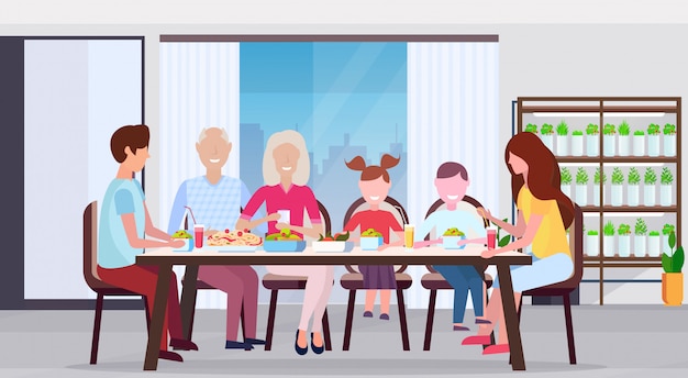 Familia de múltiples generaciones desayunando personas sentadas en una gran mesa de comedor redonda cocina moderna interior plantas inteligentes concepto de sistema plano horizontal de longitud completa