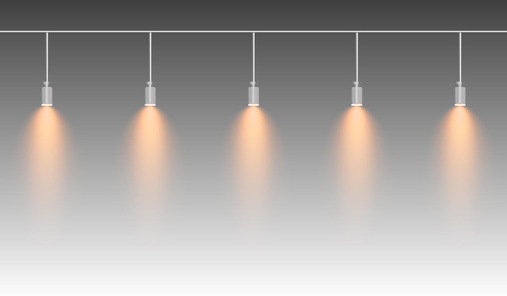Vector una fila de focos amarillos colgando de una vía, un brillo suave que ilumina hacia abajo creando un efecto de iluminación moderno, ideal para exposiciones de iluminación escénica y diseños interiores.
