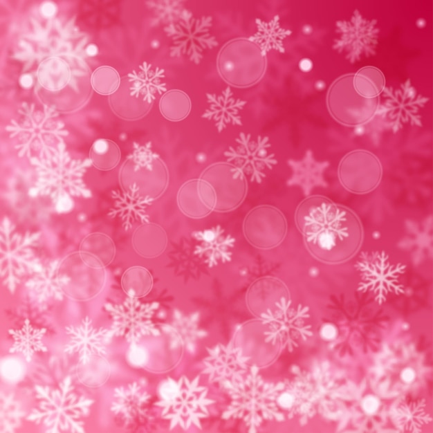 Fondo borroso de Navidad de copos de nieve cayendo grandes y pequeños desenfocados complejos en colores rosados con efecto bokeh