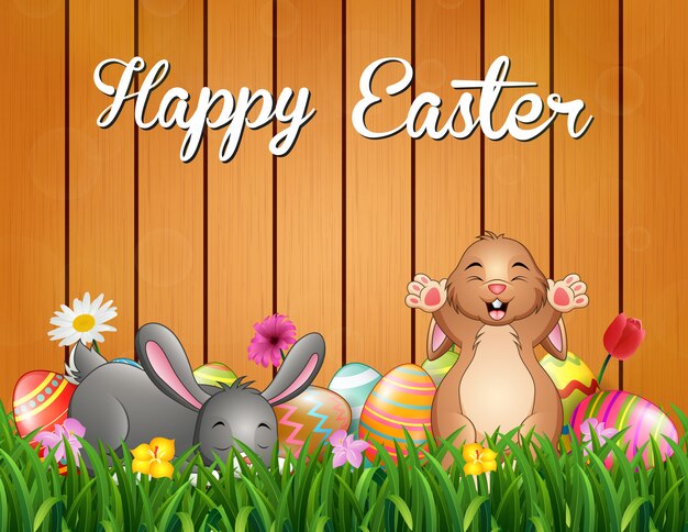 Fondo de conejitos de Pascua con huevo decorado en la hierba